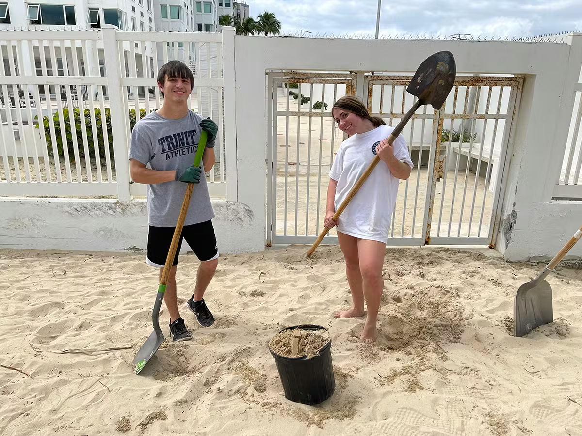 Volunteers using shovels to restore sand and dunes