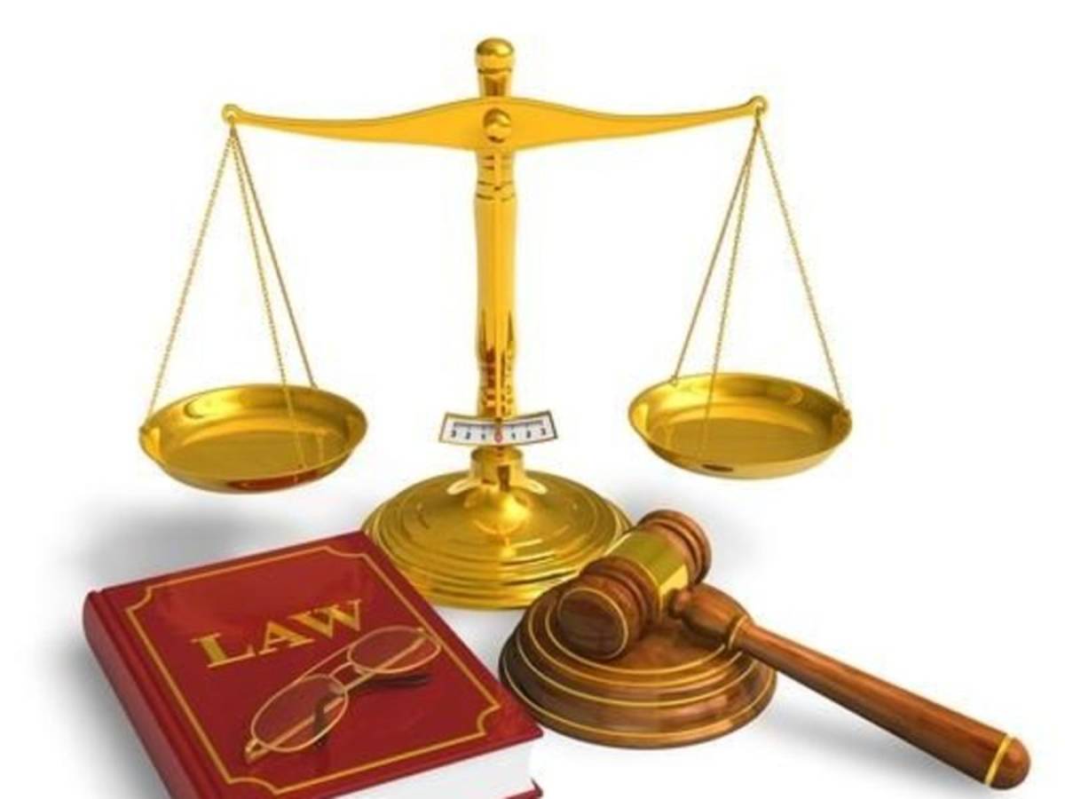 weighing scale by a book of law and gavel