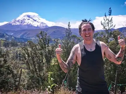 photo of a man with the mountains behind him