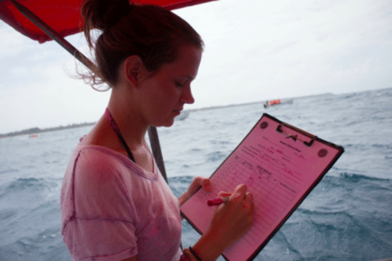 A girl recording data in the boat