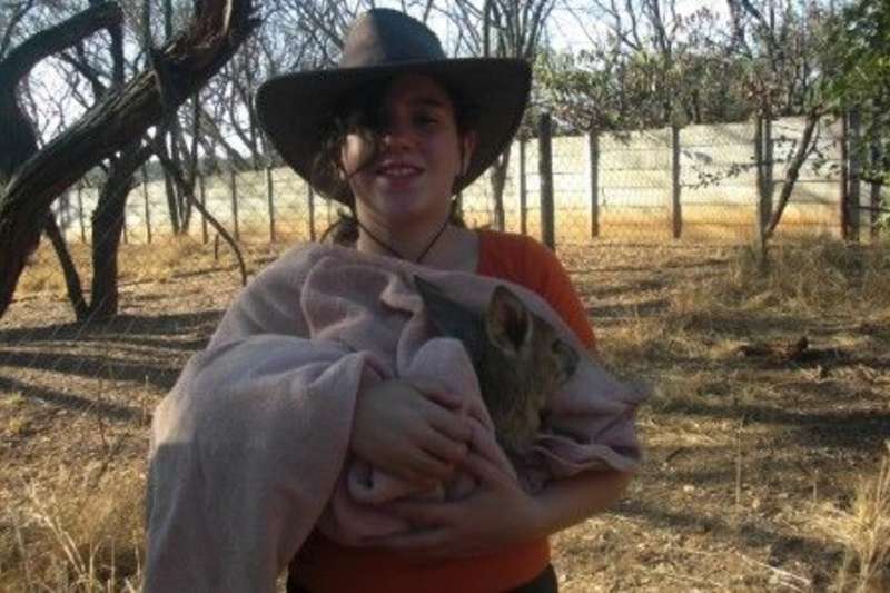 A boy holding an animal