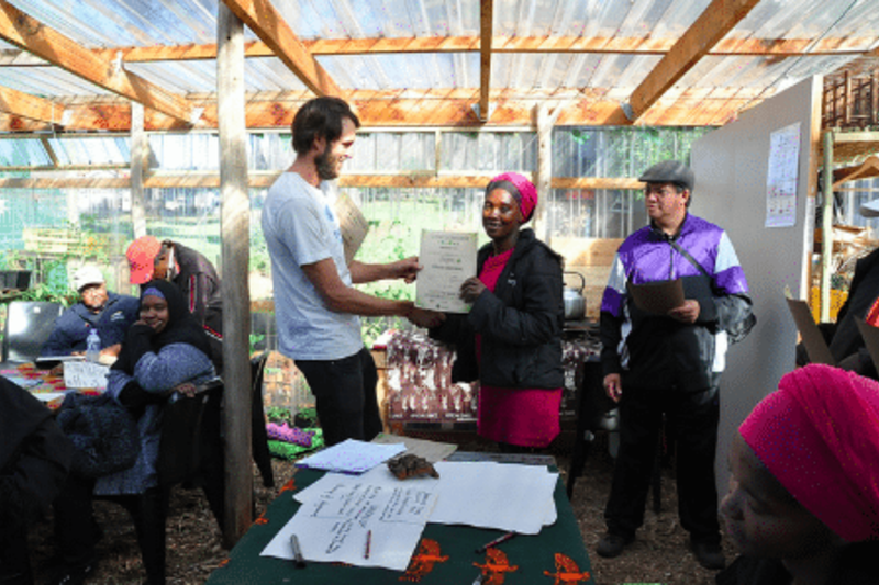 A man giving a certificate