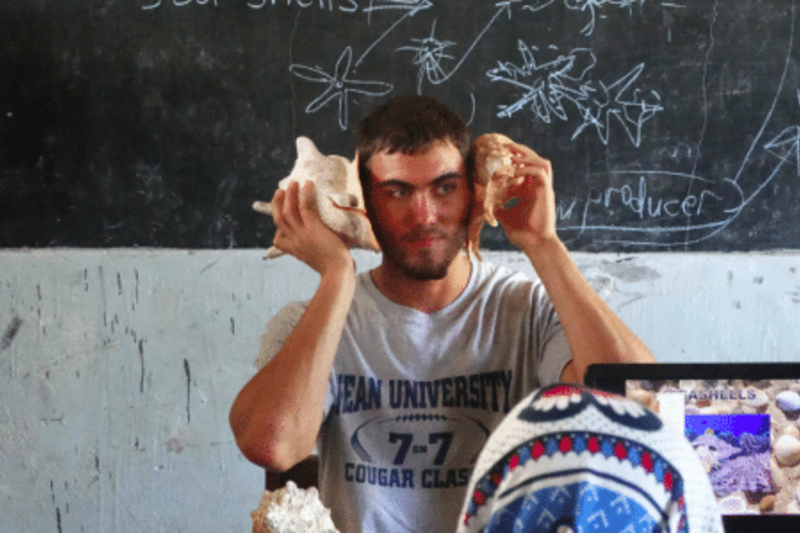 Volunteer holding the sea shells