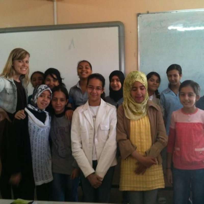A class in Morocco pose with a volunteer teacher