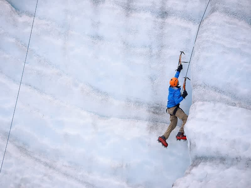 A boy ice climbing in Alaska