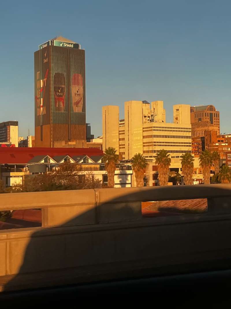 A city skyline glows gold in the South African sunset
