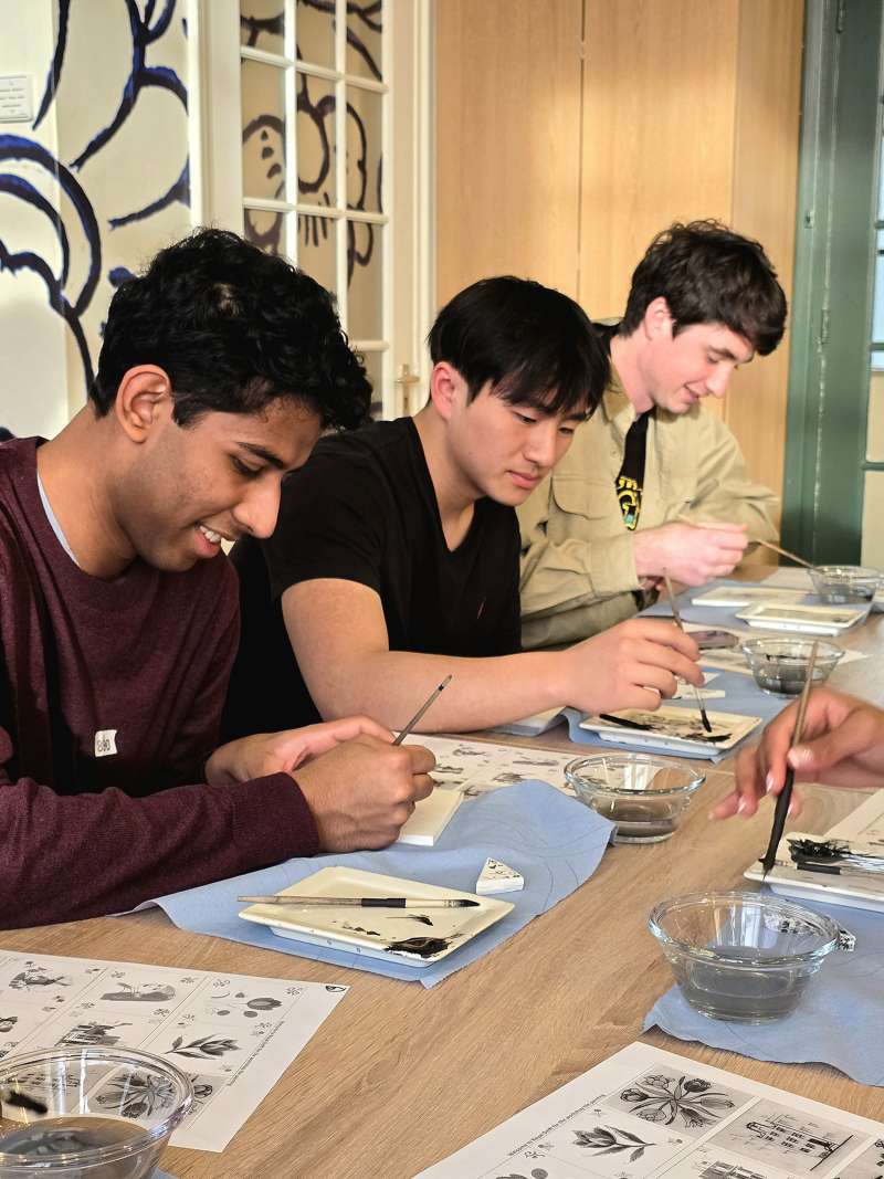A few of our spring students painting a Delft Blue tile in Delft