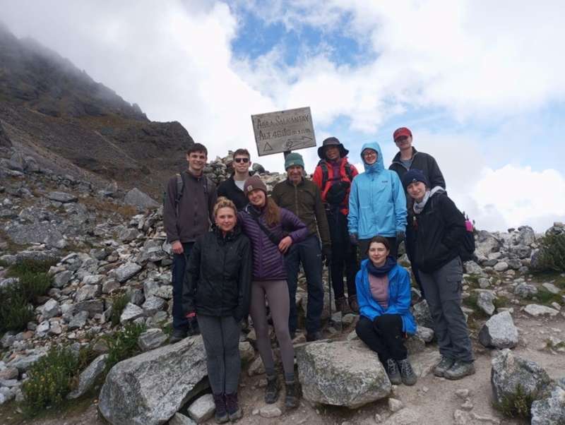 a group of hikers pose for a photo