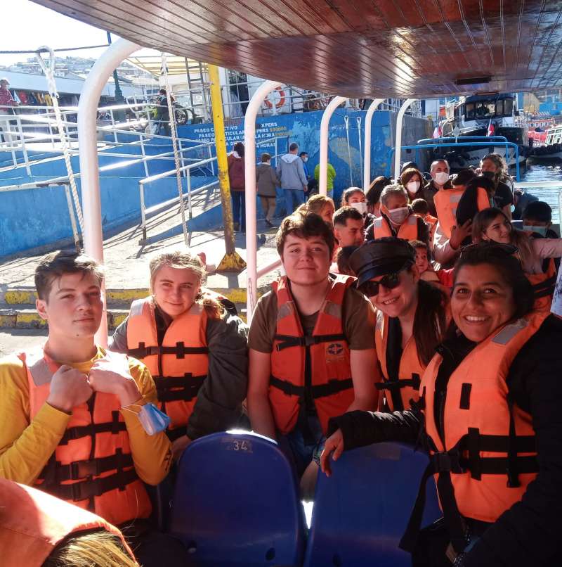 A group of interns enjoying a guided tour of Valparaíso Bay, Chile, taking in the colorful hillside city and Pacific Ocean views.