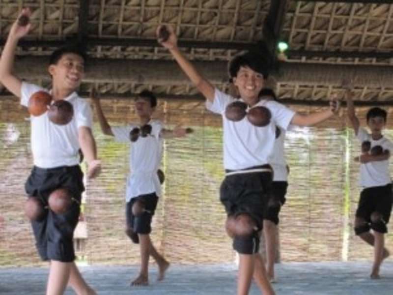 A group of young boys performing a synchronized dance.