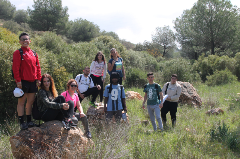 a group of young people participating in an outdoor nature activity
