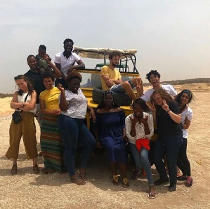 A large group of students, staff in front of a truck in Senegal