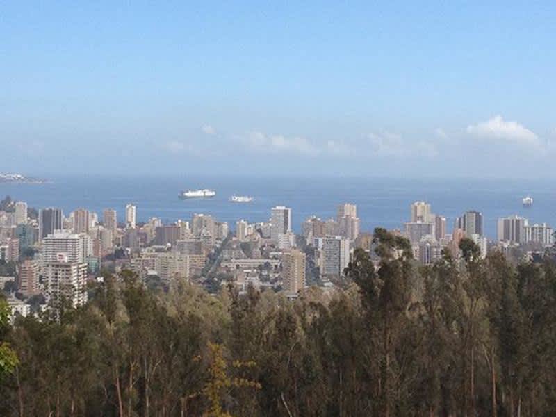 A panoramic cityscape seen from a hilltop, showcasing the urban landscape and its surrounding areas.