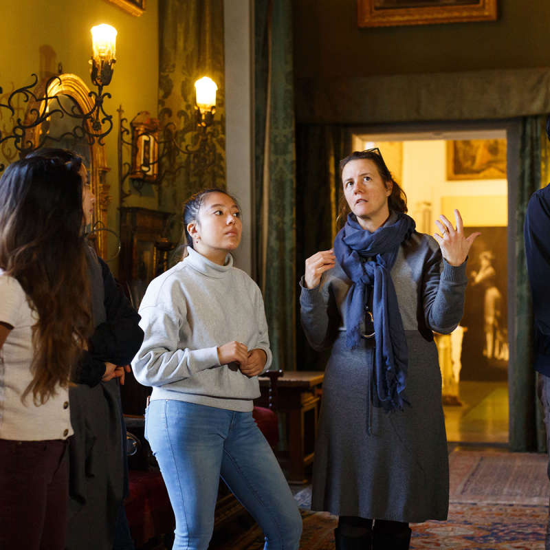 A professor explains a concept to students in Villa La Pietra.