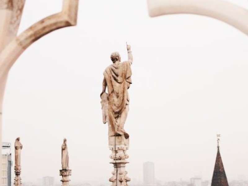 a statue atop Duomo di Milano