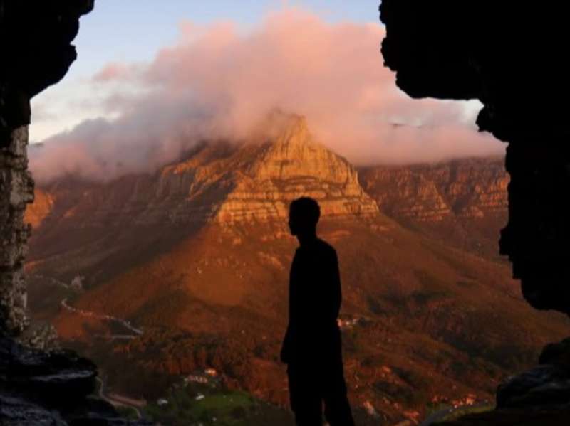 A student hikes mountains at dusk in Cape Town, South Africa.