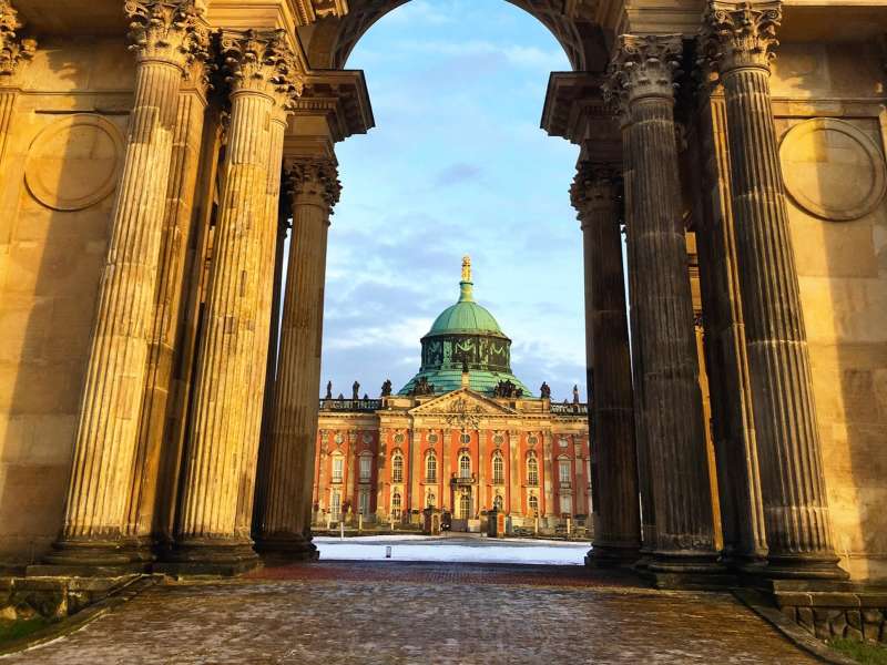 A university building behind an archway