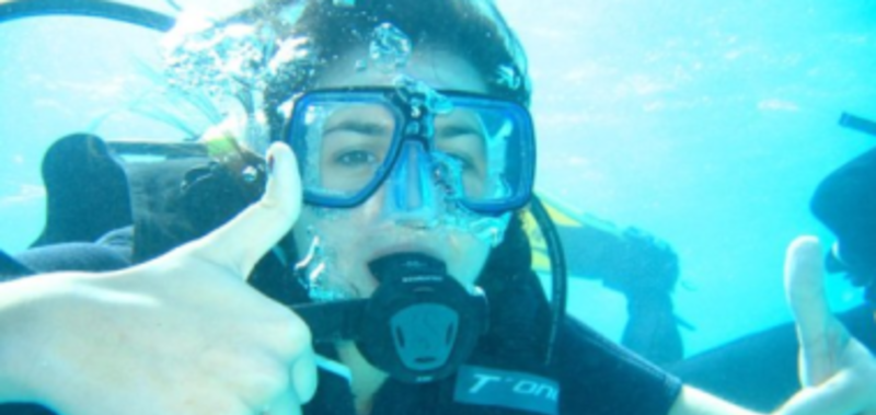 A woman in a scuba suit underwater