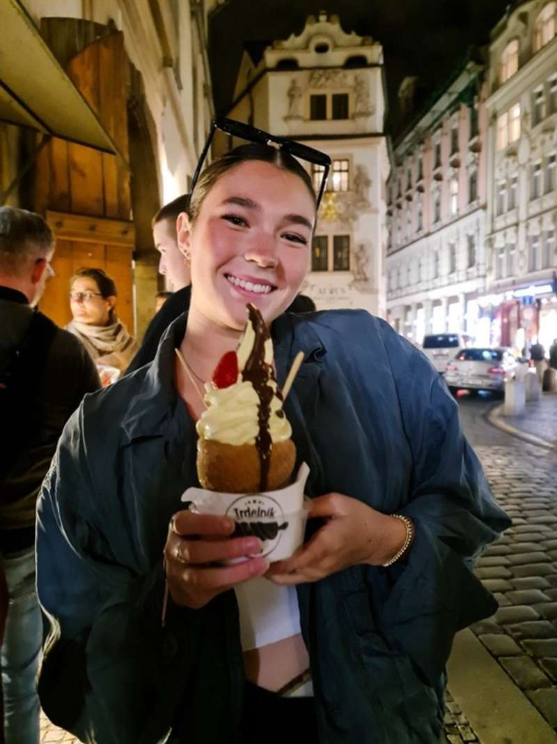 a young girl eats ice cream in Prague