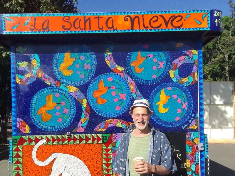 American student in front of artwork on immersion event