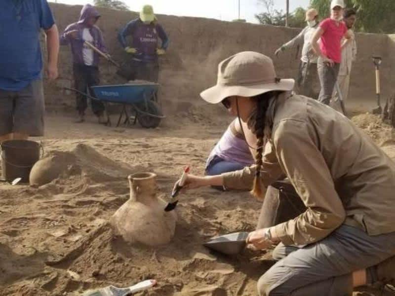 an archeologist dusting off a pot
