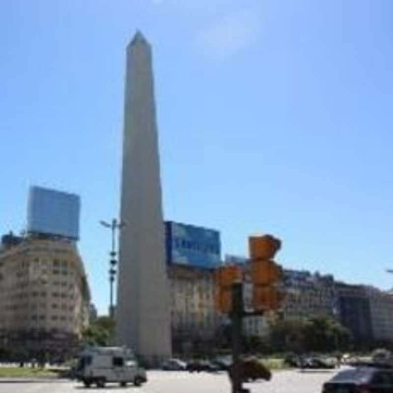 An obelisk standing tall amidst a bustling city street