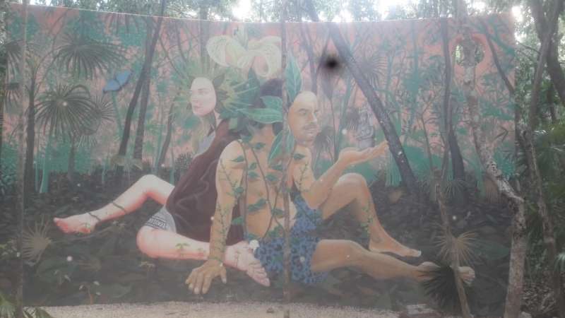 Mural of three people sitting down