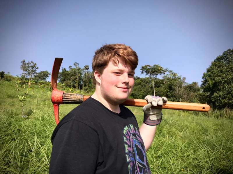 Boy posing with tool during service work
