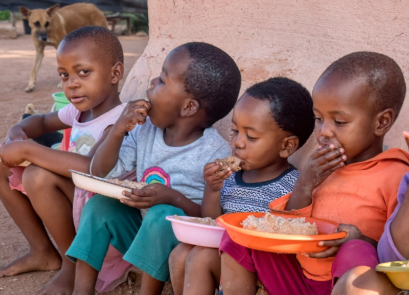 children enjoying midday meal - project work.