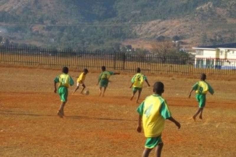 children playing football at the field