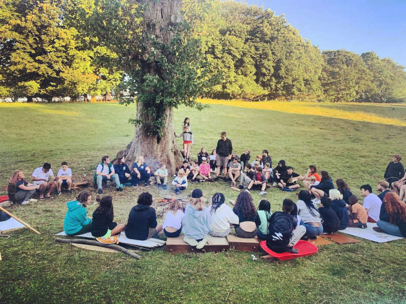 Children sat around the campfire in a circle