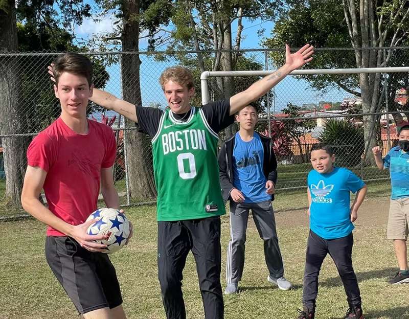 Christmas Holiday Volunteers Playing Football with Local Children