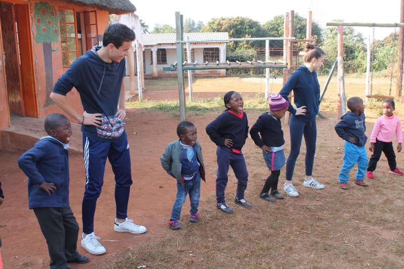 Volunteers and children dancing