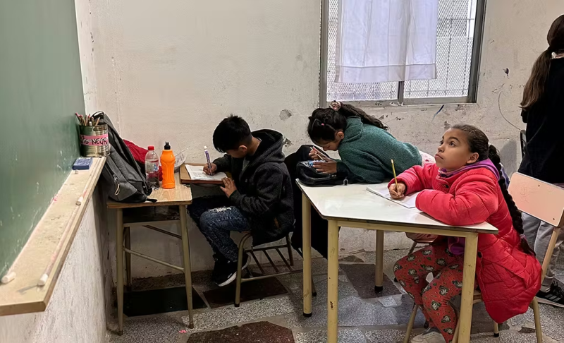 Class of children learning english from a blackboard in Argentina 