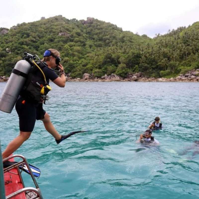 Teens running into the ocean on a summer travel trip to Thailand