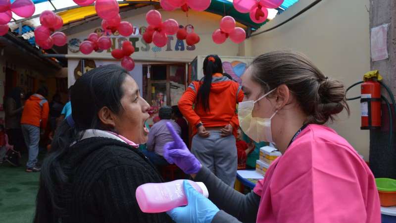 Female Volunteer checking an Elderly Patients Mouth in Costa Rica