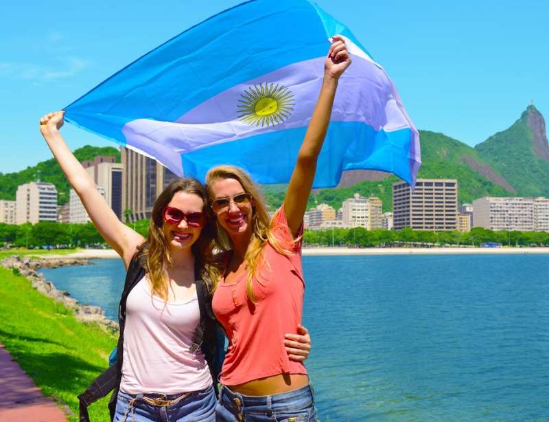 Friends holding the Argentinian flag