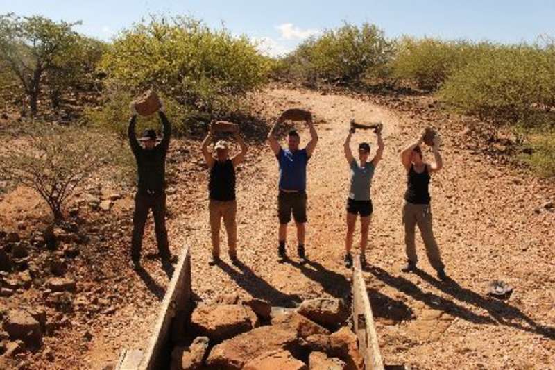 group holding rocks
