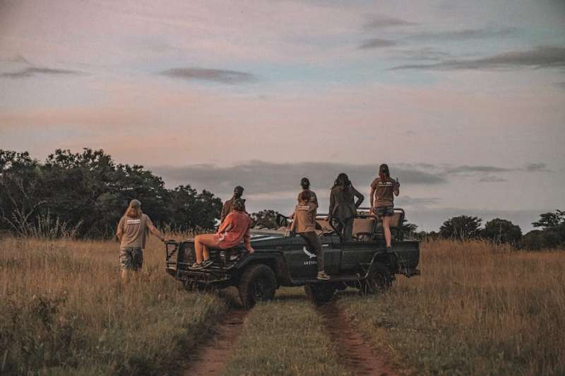 Group of ACE volunteers relaxing on a research vehicle