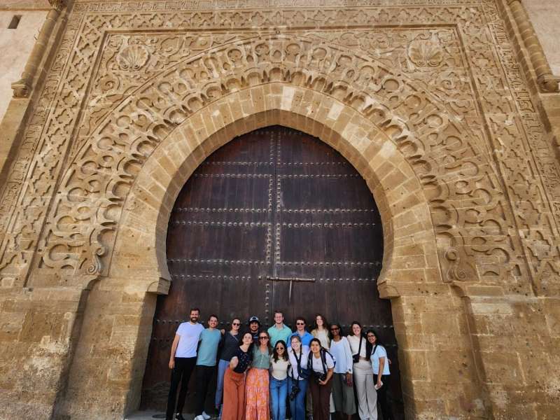Group of staff and students in front of ornate building in Rabat