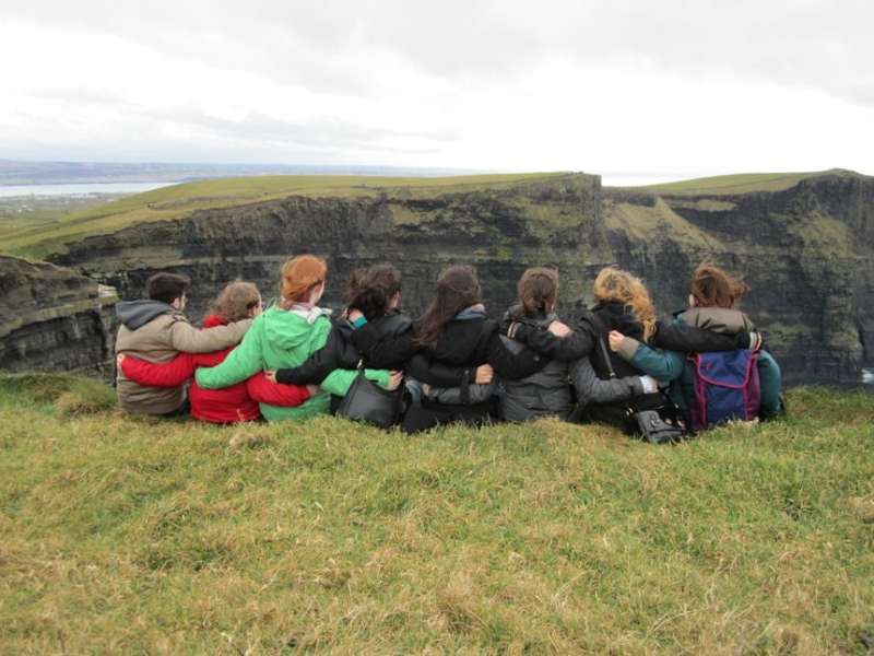 Group of students posing on cliff in Ireland