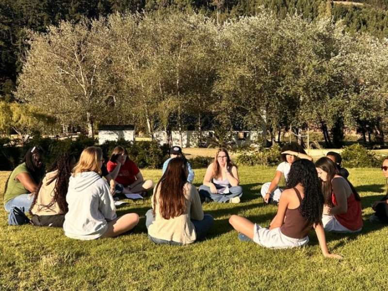 Group of students sit together during orientation outside in Cape Town