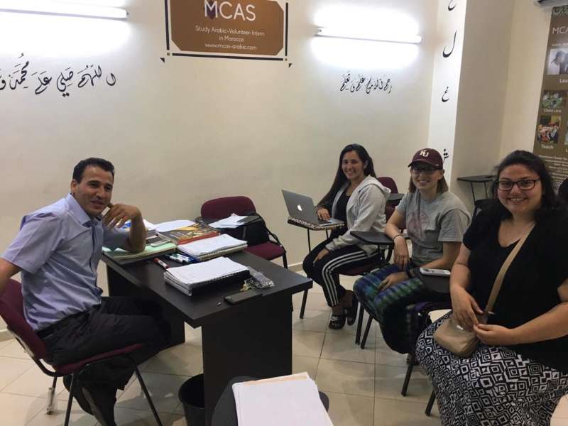 volunteers with teacher learning Arabic