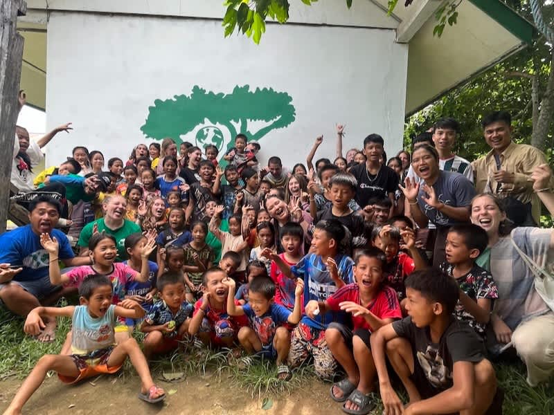 Happy and excited local community in rural Laos with volunteers