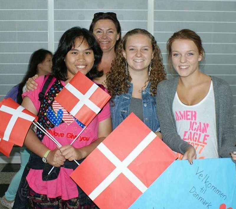 A group of high school students holding Danish flags in Denmark.