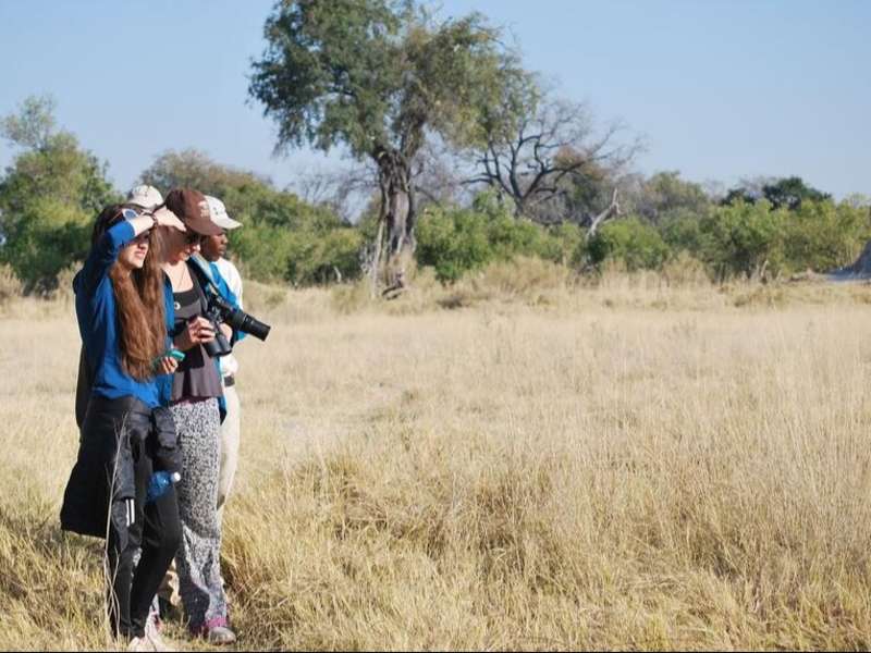 High school students taking photos in the delta in Botswana