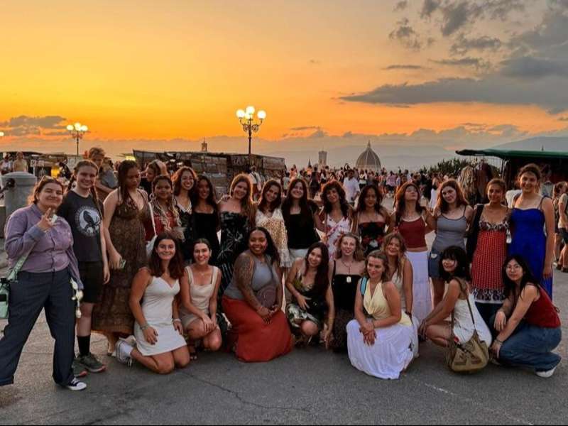 High schoolers posing as group on program at sunset in Florence