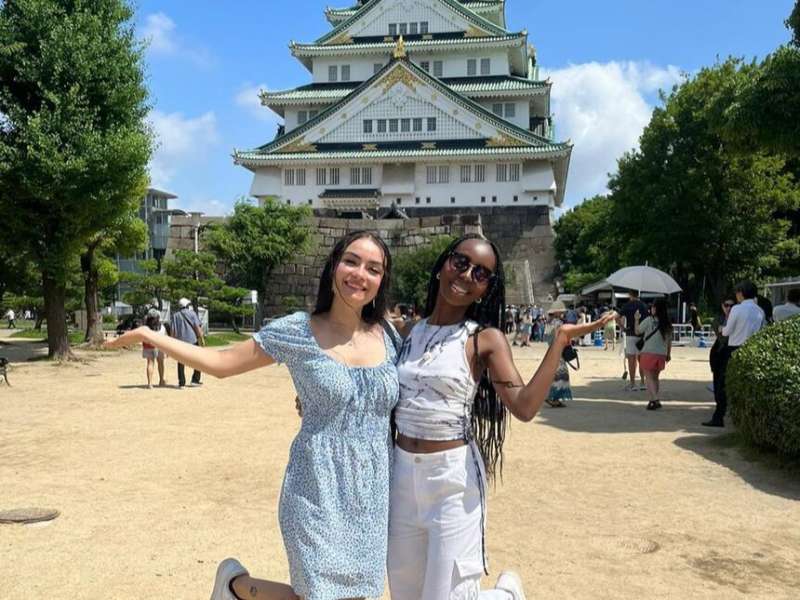 High schoolers posing in front of Osaka Castle in Japan