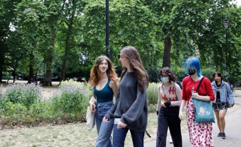 High schoolers walking in a park in London
