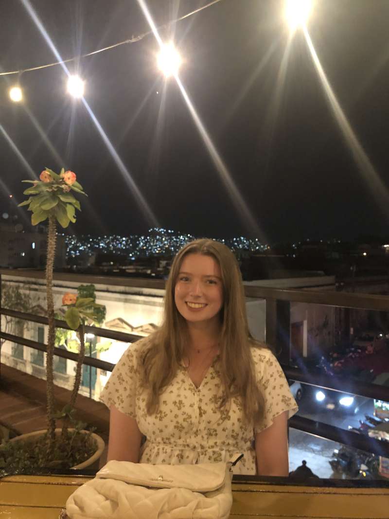 Intern enjoying nightlife in Oaxaca, Mexico, socializing in a lively outdoor setting with local lights and music.